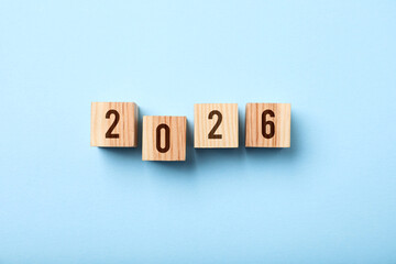 New 2026 year. Cubes with numbers on light blue background, top view