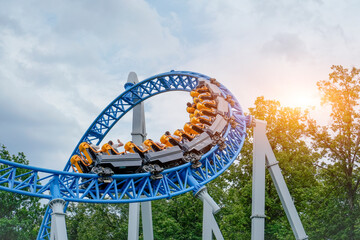 Exciting roller coaster speeding through loops and turns at a vibrant amusement park, capturing the thrill, energy, and fun of high-speed theme park adventures.