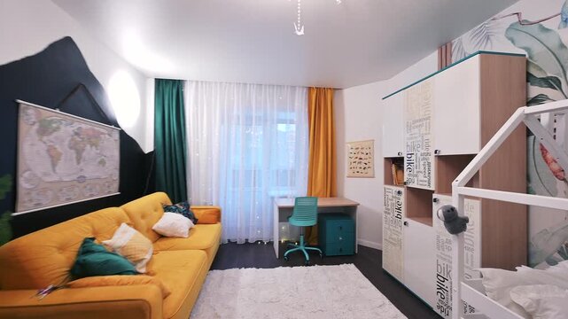 Playful kids room with a black mountain wall, orange sofa, and jungle mural. Features a house bed, study desk, and vibrant, modern decor for a cozy, creative space.