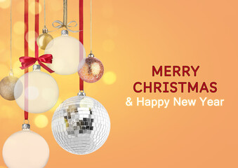 Merry Christmas and Happy New Year card. Shiny disco ball and festive ornaments on coral background, bokeh lights