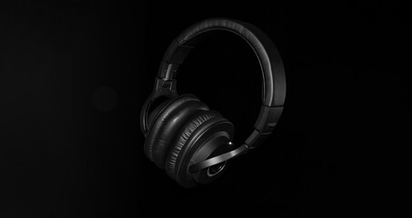 Black professional headphones on a black background. Musical production. Sound studio and DJ equipment. Sound engineer working tool. Closed-back Headphones for music lovers. Contours and outlines. 