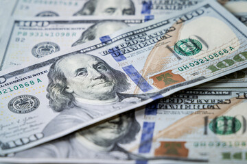 Hundred dollar bills are scattered on the table. Finance of the United States of America.