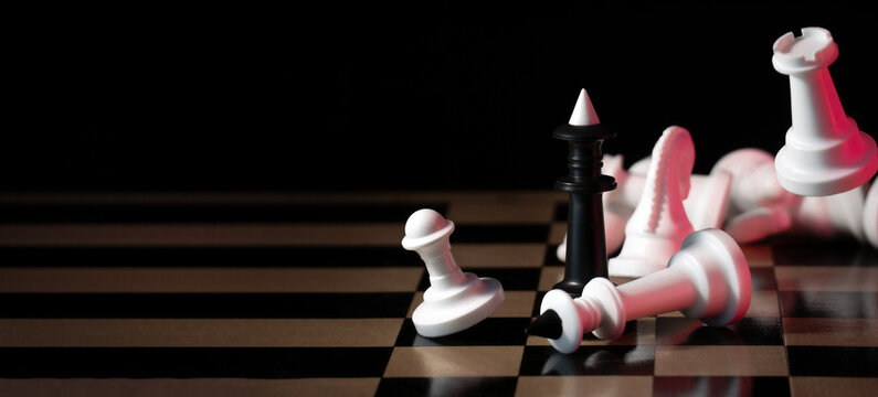 Winner. A black king surrounded by white chess pieces in a chess board game competition. Check and mate. Chess match. Bright red light. Acid colors. The concept of a successful team work leader. - Powered by Adobe