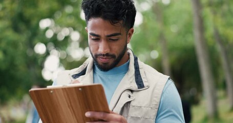 Man, volunteer and writing on clipboard outdoor for charity event, donation list and stock control. Male person, notes and checklist for food drive, community outreach and schedule of society welfare