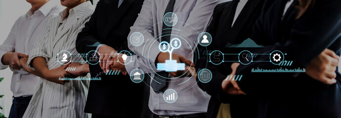 A group of professionals engages in a discussion about financial strategies, surrounded by digital graphics that enhance collaboration and innovation in a modern office setting. Trope