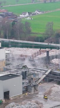 industrial plant factory site oudegem belgium emphasis placed steam rising from recycling paper operations aerial drone panning shot vpk packaging group view 