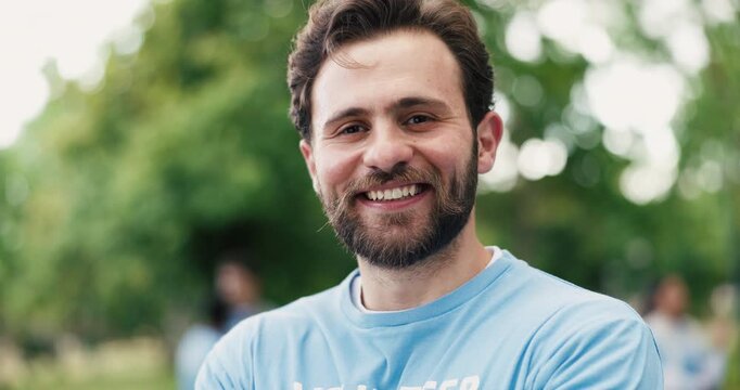 Face, volunteer and man outdoor with smile for eco friendly project, outreach and nonprofit service. Happy, person and charity work in park for sustainability program, social responsibility or bokeh.
