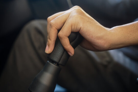 man hand switching a manual gear shift in the car - Powered by Adobe