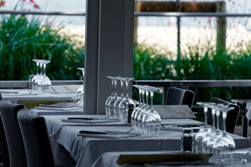 Table set with white wine glasses ready for restaurant guests