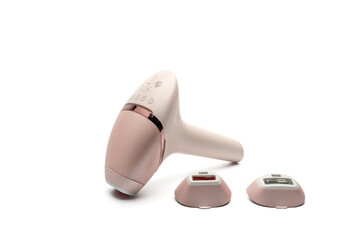 IPL hair removal handset standing with control buttons visible and two treatment heads in front on white background. Modern beauty tool for home use.