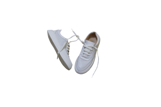 white leather sneakers on a white background, summer women's sneakers with holes isolated on a white background