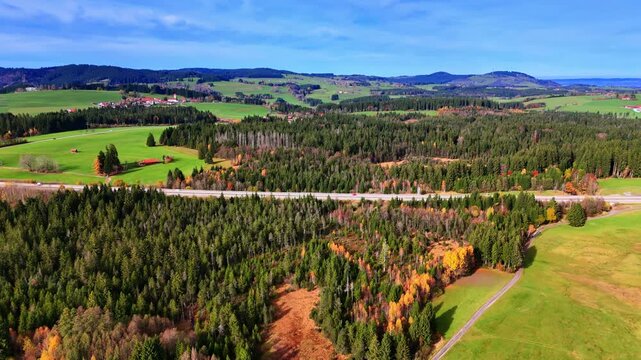 Green hills and forest panorama. German countryside of forests, hills and scattered fields in autumn.