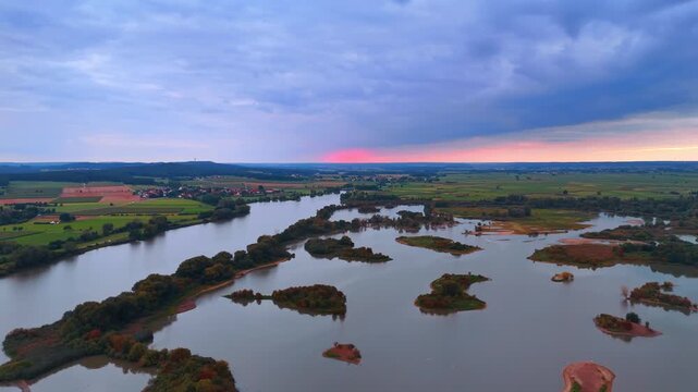 River islands at sunset. German river landscape with small islands under dramatic sunset clouds.