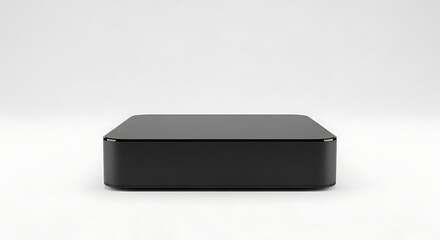A sleek black box sitting on a white surface with a minimalist and modern presentation style image