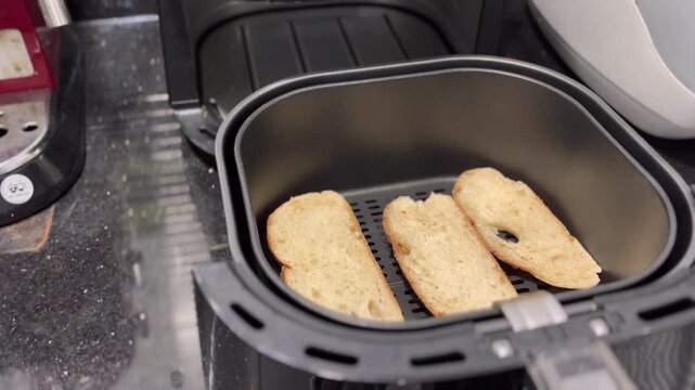 In the oven, sourdough bread bakes to a beautiful crispy crust. Opening the oven after baking, steam rises as the bread is removed.