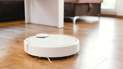 White robot vaccum cleaner in the living room