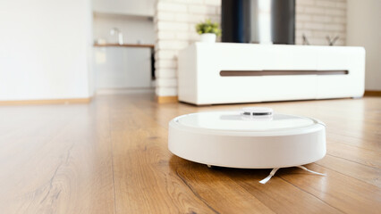 White robot vaccum cleaner in the living room