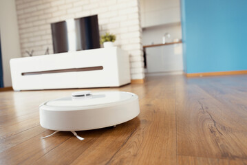 White robot vaccum cleaner in the living room