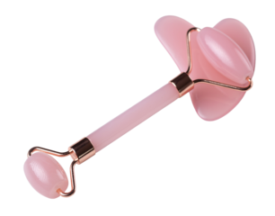 Pink Gua Sha massage tool on a white background, close-up. Rose Quartz jade roller.