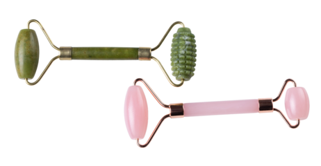 Two cosmetic facial rollers, rose quartz crystal and jade isolated on white background, top view