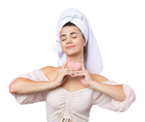 Beautiful cheerful attractive girl with a towel on her head, holds a sponge in the form of a pink heart.