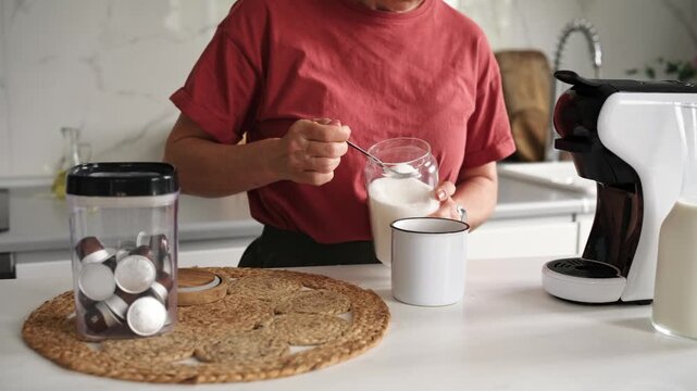 Woman Adds Sugar To Coffee In A Close-Up Shot In The Kitchen At Home