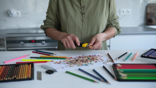 Close-Up Of A Woman Sharpening Colored Pencils