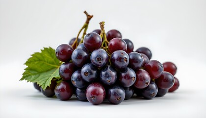 Fototapeta premium A collection of round, dark colored grapes with visible seeds. They are grouped together, suggesting freshness and abundance, set against a neutral background that highlights their vibrant color.