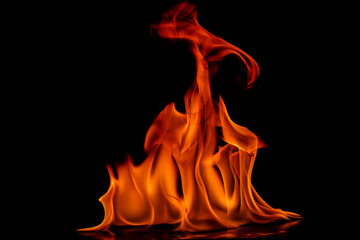 Dense clustered flames with striking red coloring at peak fading to bright orange base against...