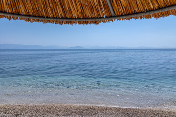 View from beach in Benitses town on the Ionian Sea shore on Corfu Island, Greece
