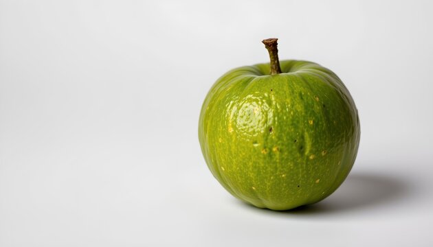 An apple, its skin a vibrant green that contrasts with the background. This apple is not just any ordinary fruit, but rather one adorned with spots, suggesting it might be slightly overripe