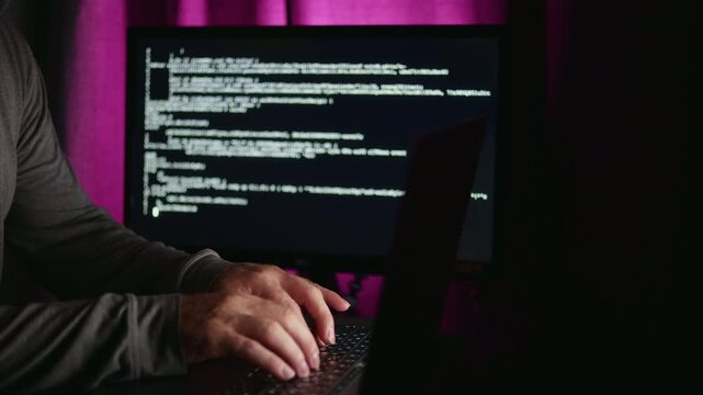 Researcher trains model using laptop code in pinkpurple ambient light neural network scripts and dataset pipelines visible on monitor, focused scientific atmosphere with close-up on hands and keyboard