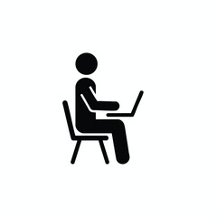 Person working on a laptop computer while seated on a chair