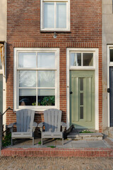 Cozy facade featuring an inviting front porch with a pair of chairs.