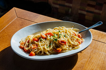 Delicious-looking pasta with tomatoes and herbs, ready to be enjoyed.