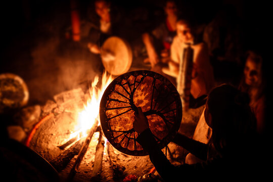 Night fire ceremony. Women play shaman drums.
