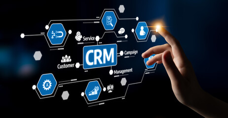 A hand reaching for a touchscreen interface displaying CRM elements, emphasizing customer management and campaign strategies in a digital business environment. Tessel