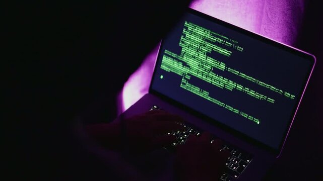 Hacker style with illuminated workspace, Computer screen displaying active code during cybersecurity testing process, Vivid scene of coding on purple screen with neon highlights and shadowed desk