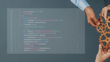 A captivating image showing hands working together over a gear mechanism with programming code. This visual emphasizes collaboration and technology in the business landscape. Raster