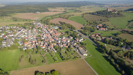 Aerial panorama view of the old town of the city Altwiedermus 63549 and castle Ronneburg in Germany on a sunny morning in autumn, fall.