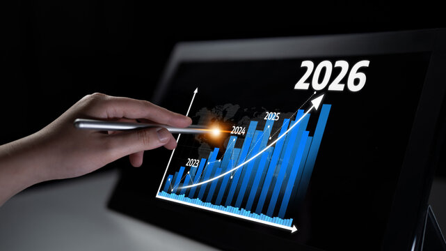 A close-up view of a hand holding a pen, analyzing a digital growth chart with projected data from 2023 to 2026, illustrating business success in a modern environment. Tessel