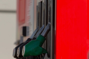 fuel nozzle details, detailed view of industrial fuel pump handle, examination of fuel nozzle with metallic handle and reflections, close inspection of fuel pump parts and maintenance features © Viktar