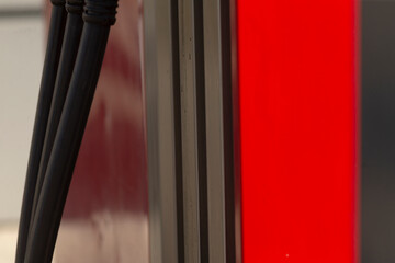 detailed view of fuel dispenser nozzle and panel, closeup shot highlighting gas pump nozzle and urban environment, detailed closeup of fuel dispenser nozzle with urban background and panel features © Viktar
