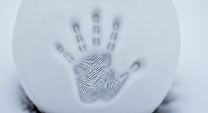 Handprint fingerprint in white material close up showing unique identity and individuality symbolization