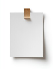 Square white paper attached with a brown clip, shadow below