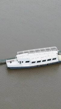 top abandoned passenger river transport boat or pleasure ferry ship vessel appears to be dilapidated state circling aerial drone shot view temse belgium 
