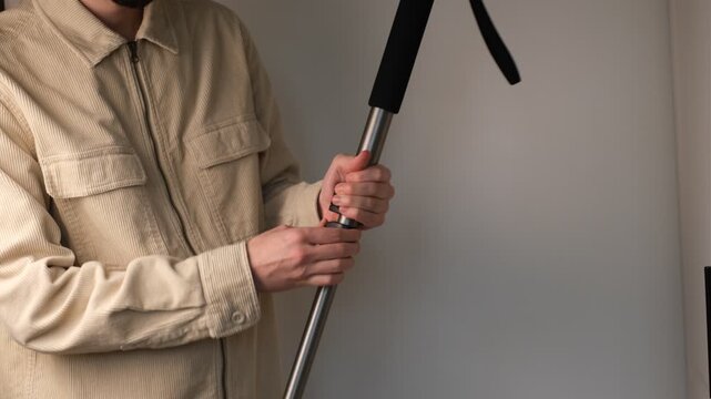 Man assembling monopod close-up of hands