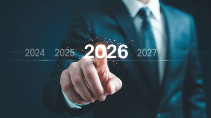Businessman touching the year 2026 on a futuristic digital interface