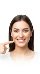Smiling young woman pointing confidently at her healthy, bright white teeth, showcasing excellent oral hygiene and a radiant, beautiful smile that emphasizes dental wellness and beauty with joy