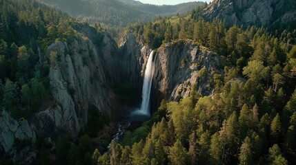 A majestic waterfall cascades down a rocky cliff, surrounded by tall green trees and a dense forest. The beautiful waterfall creates a tranquil setting in this untouched natural la